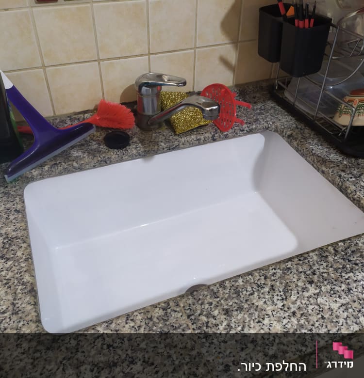 כיור מטבח עם ברז וכלי ניקוי